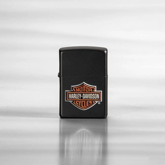 Lifestyle image of Harley-Davidson® Texture Print Classic Logo Black Matte Lighter, standing on a sheet of metal