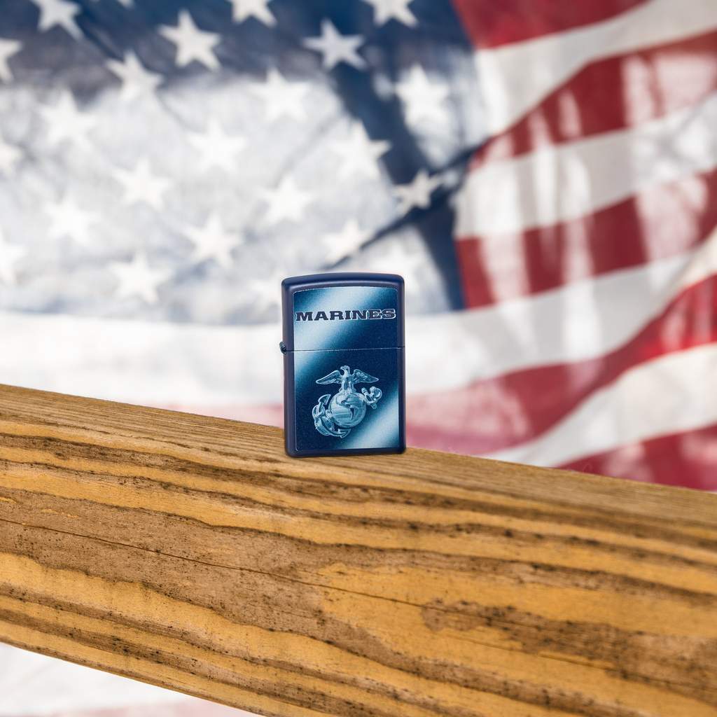 Lifestyle image of U.S. Marines Corps. Navy Matte Windproof Lighter with the American Flag in the background